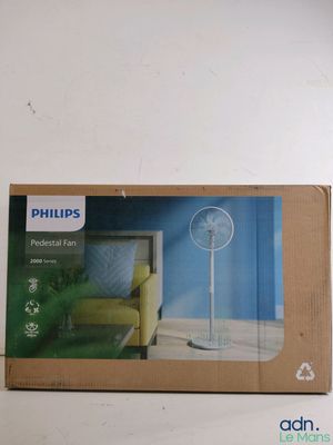 packaging of a philips fan on a white wall with a yellow chair