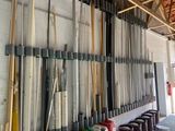 many baseball bats hanging on the wall in the garage