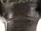 a bronze statue of a man ' s head on a table