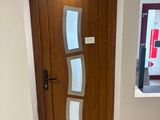 a wooden door with a glass window in a room