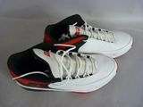 pair of white and black sneakers with red accents on a white surface