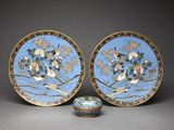 pair of blue and gold plates with birds and flowers on them