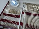 many spoons and silverware in a box on a table