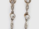 a pair of diamond and gold earrings
