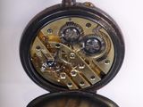 a pocket watch that is open on a white surface