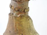 a close up of a vase with a bird on top of it
