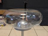 a glass object on a metal stand in a room
