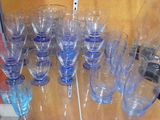 bottles and glasses on a shelf with a cord attached to them