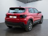 the rear end of a red suv parked in a garage