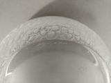 a close up view of a white vase with flowers on it
