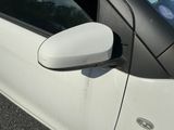 an image of a white car with a mirror on the side of it