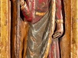 statue of a man holding a cross and a staff in a gold frame