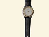 a black watch with a white face on a black strap
