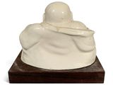statue of a woman holding a baby in her arms on a wooden base