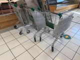 two shopping carts that are on the floor in the store