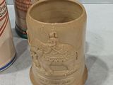 three beer mugs sitting next to each other on a table