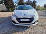 the front view of a white car parked in a parking lot