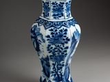 a blue and white vase that is sitting on a table