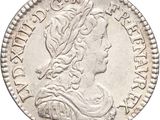 a silver coin with a bust of a woman on it