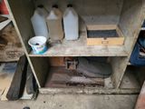 a shelf with two bottles of water and a bucket on it