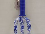 a blue and white flowered plastic fork with a blue handle