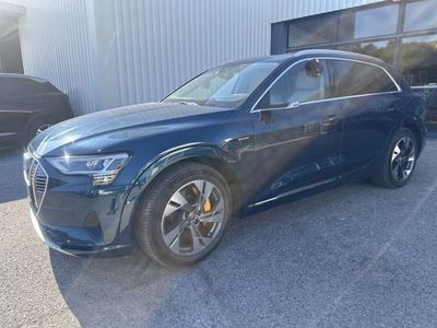 a blue audi suv parked in front of a building