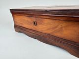 a wooden box that is sitting on a white surface