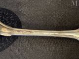 a silver spoon with a spoon handle on it