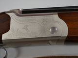 the side view of a shotgun with a wooden handle and a metal trigger
