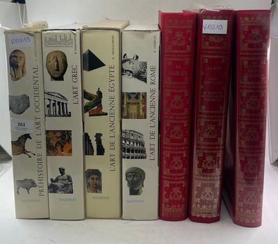 several books are lined up in a row on a table