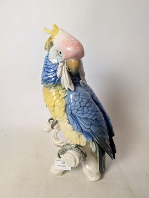 a figurine of a parrot sitting on a branch