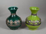 two green vases sitting next to each other on a table