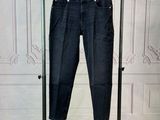 a pair of jeans hanging on a clothes rack in a room
