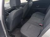 the back seats of a silver car with a black seat belt