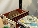 many crates and boxes of art and crafts on the table