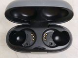 a close up of a pair of black earphones in a case