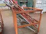 many baseball bats in a cage next to a dumpster