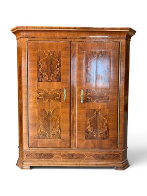 a wooden cabinet with carvings on the doors