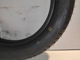 a close up of a tire on a white surface