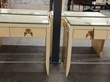 pair of art deco side tables with glass tops and brass hardware