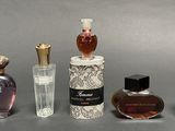 several different types of perfume bottles are lined up on a table