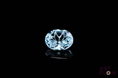 a close up of a blue diamond on a black surface