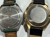 two watches sitting next to each other on a table