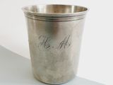 a silver cup with writing on it sitting on a table
