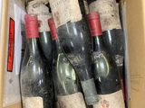 many bottles of wine in a box on the table