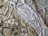 a bed that has a bunch of quilts on top of it