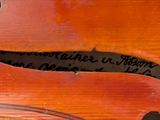 a close up of a piece of wood with writing on it