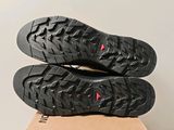 the soles of a pair of black shoes on top of a cardboard box