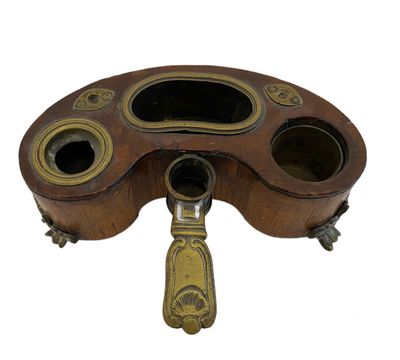 an old fashioned brass plate with a wooden handle on a white background
