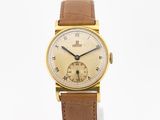 an image of a gold wrist watch with roman numerals